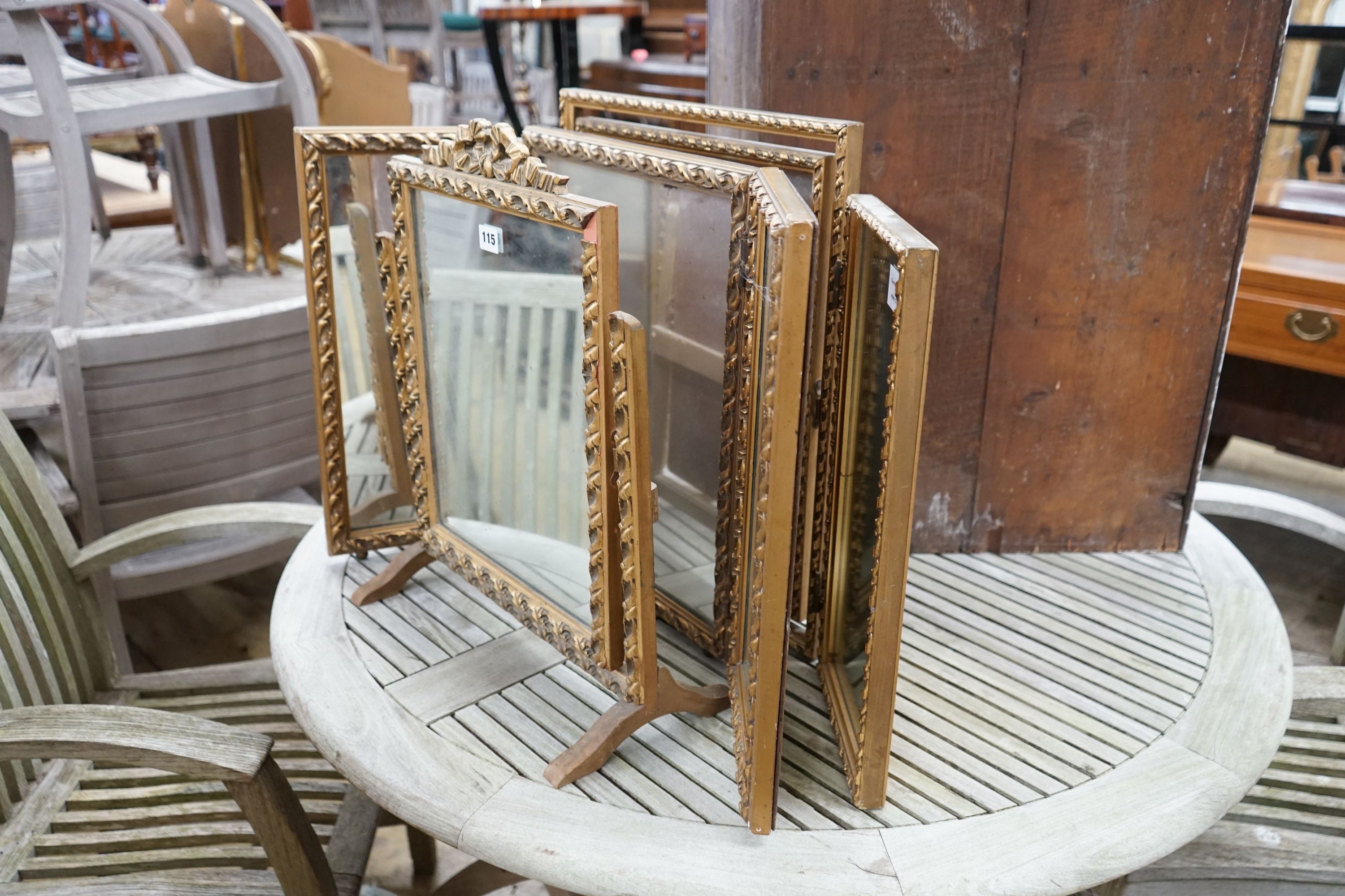 Two gilt framed triple dressing table mirrors together with a similar toilet mirror, largest height 52cm